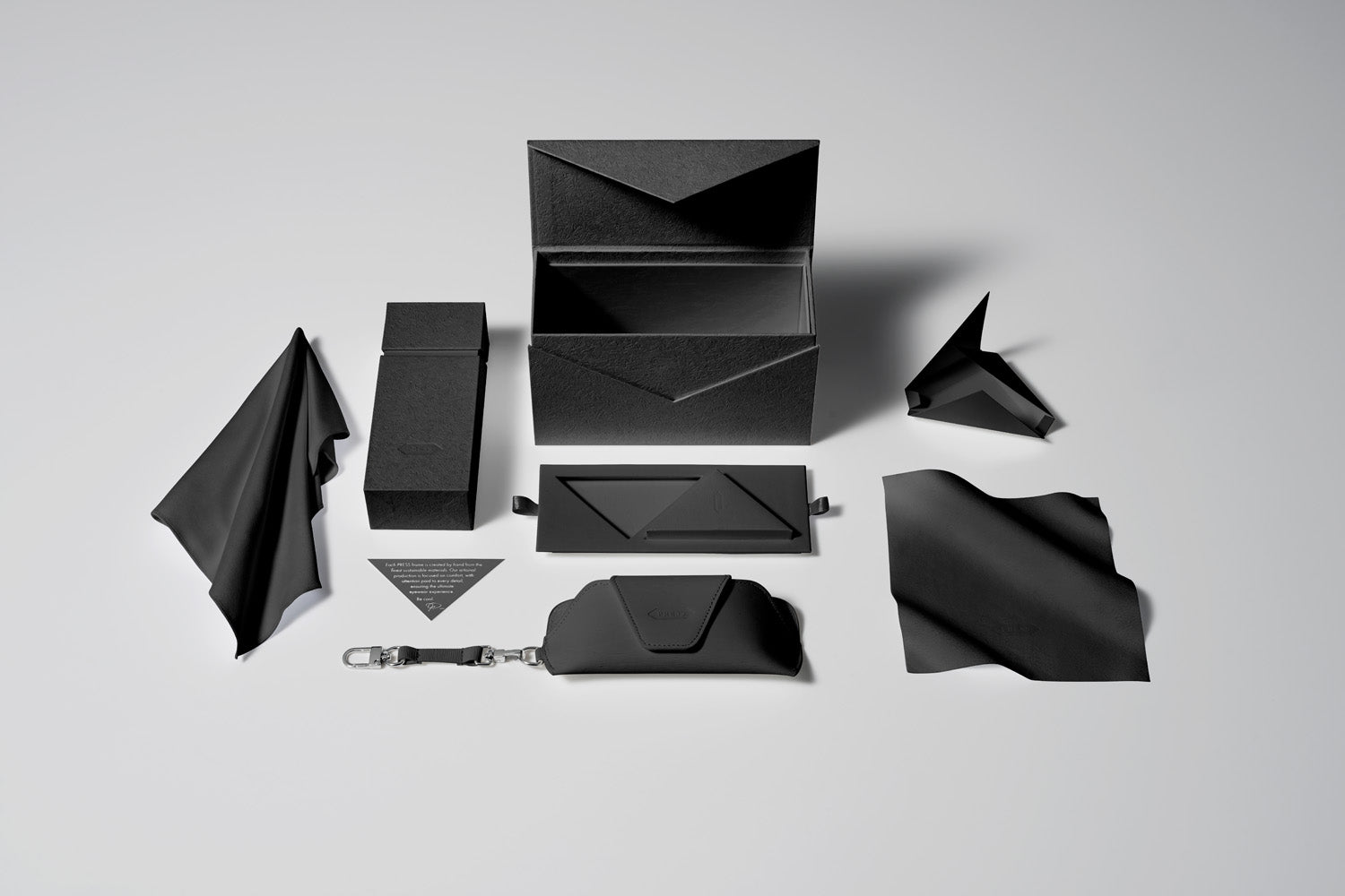 PRESS Matte Black Collection: Collectors Box, Hard case, Soft Case, Care Card, Large and Small Cleaning Cloth.